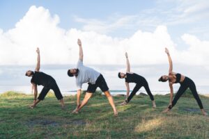 Flexible people training togetherness during daytime for holistic retreat healing