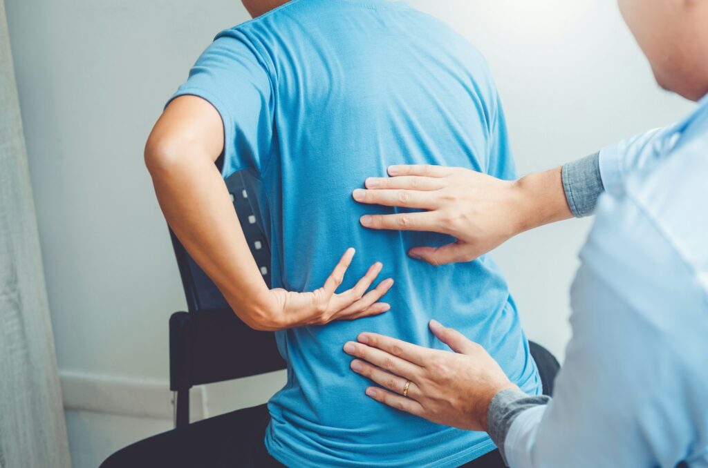 Doctor consulting with patient Back problems Physical therapy concept